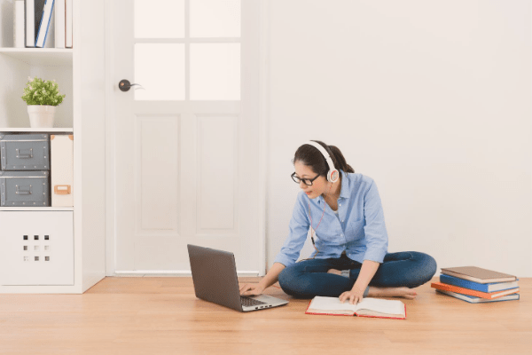 Girl studying on the floor on laptop